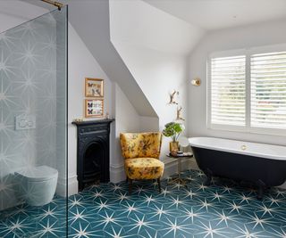 bathroom renovation with freestanding bath and star tiles