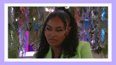 Ella Thomas pictured wearing a green blazer on the terrace in Love Island season 10/ in a purple template