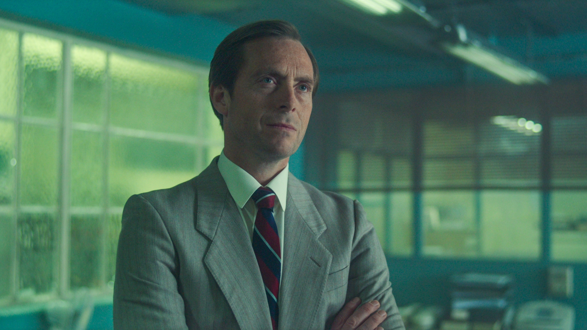Lundy stands with his arms crossed in The Gold season 2
