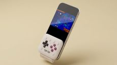 8BitDo FlipPad connected to a phone on a yellow background