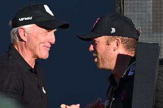 Greg Norman and Talor Gooch chat at a trophy ceremony