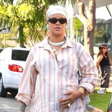 Rihanna wearing a striped pajama set and pink satin tabi flats in Los Angeles