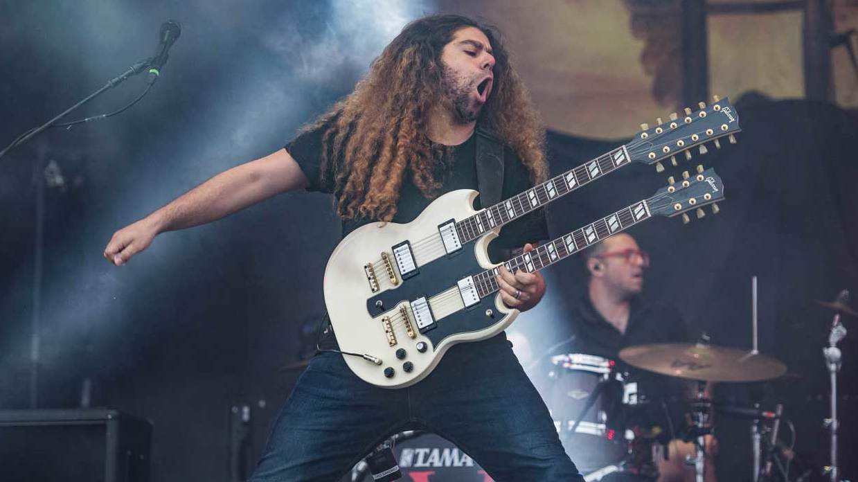 Claudio Sanchez from Coheed And Cambria playing his double neck guitar on stage