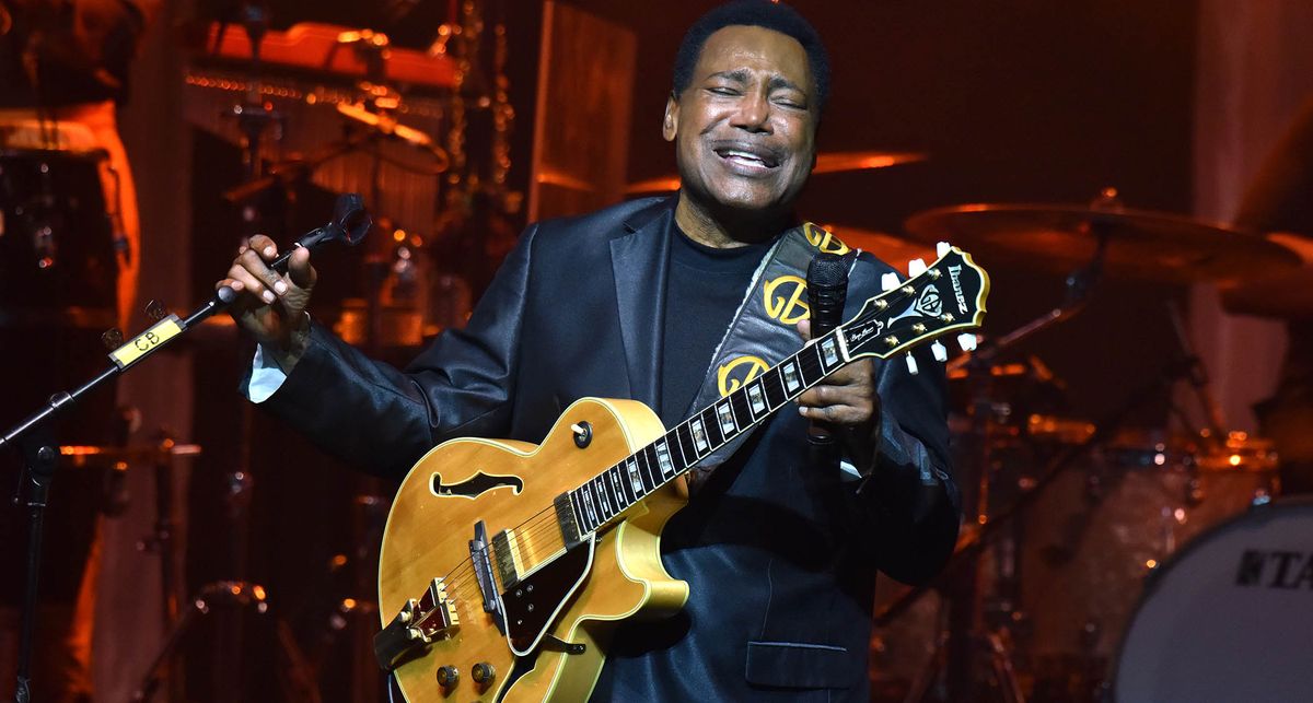 George Benson is really feeling it onstage as he performs in England in 2022 with his signature Ibanez jazz box