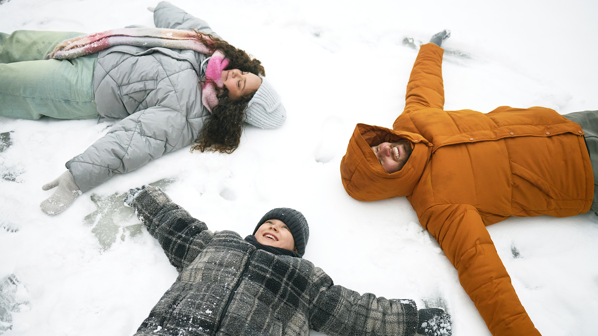 Family making snow angels