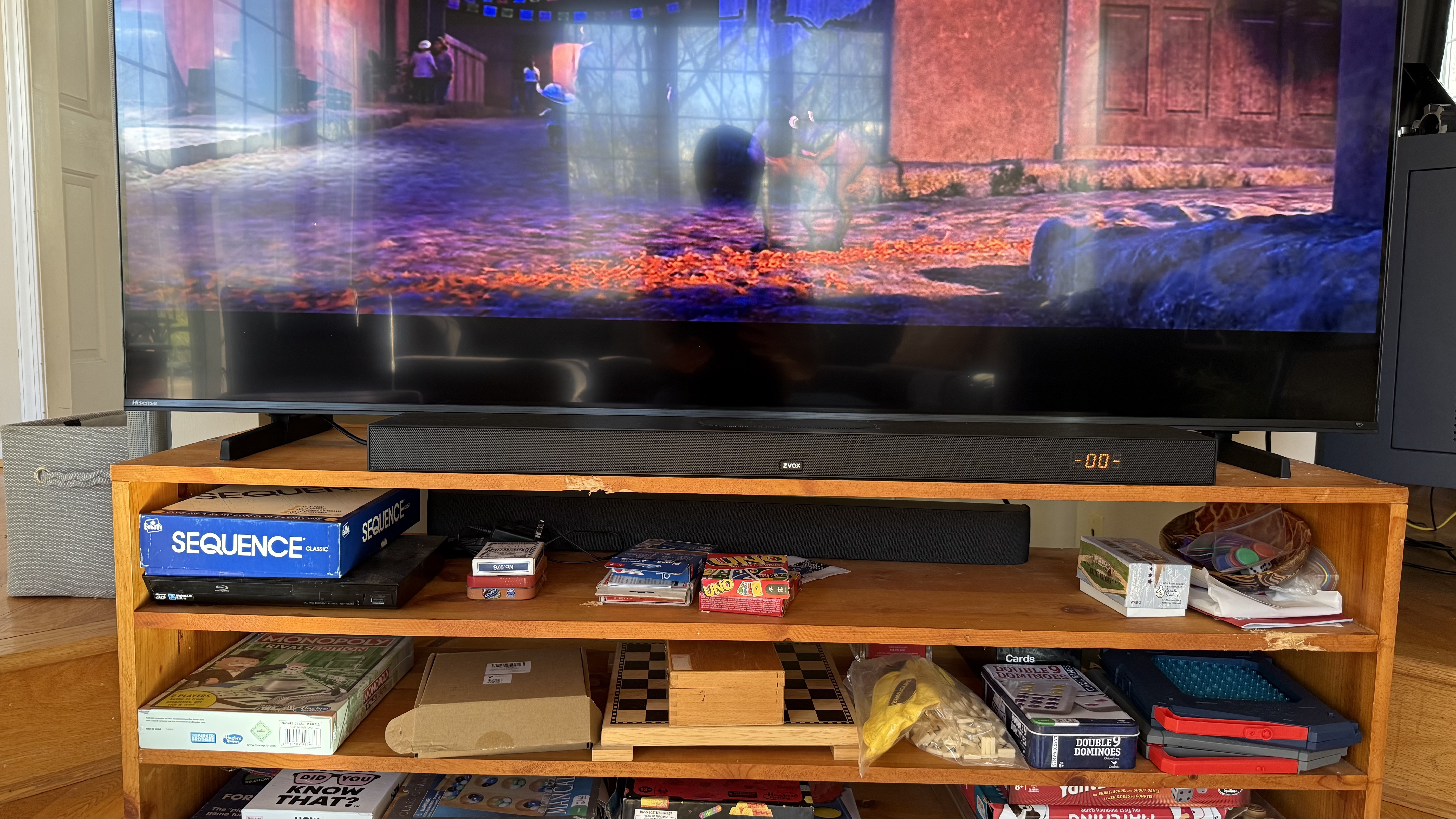 The Zvox AccuVoice AV855 soundbar pictured under a TV on a wooden cabinet