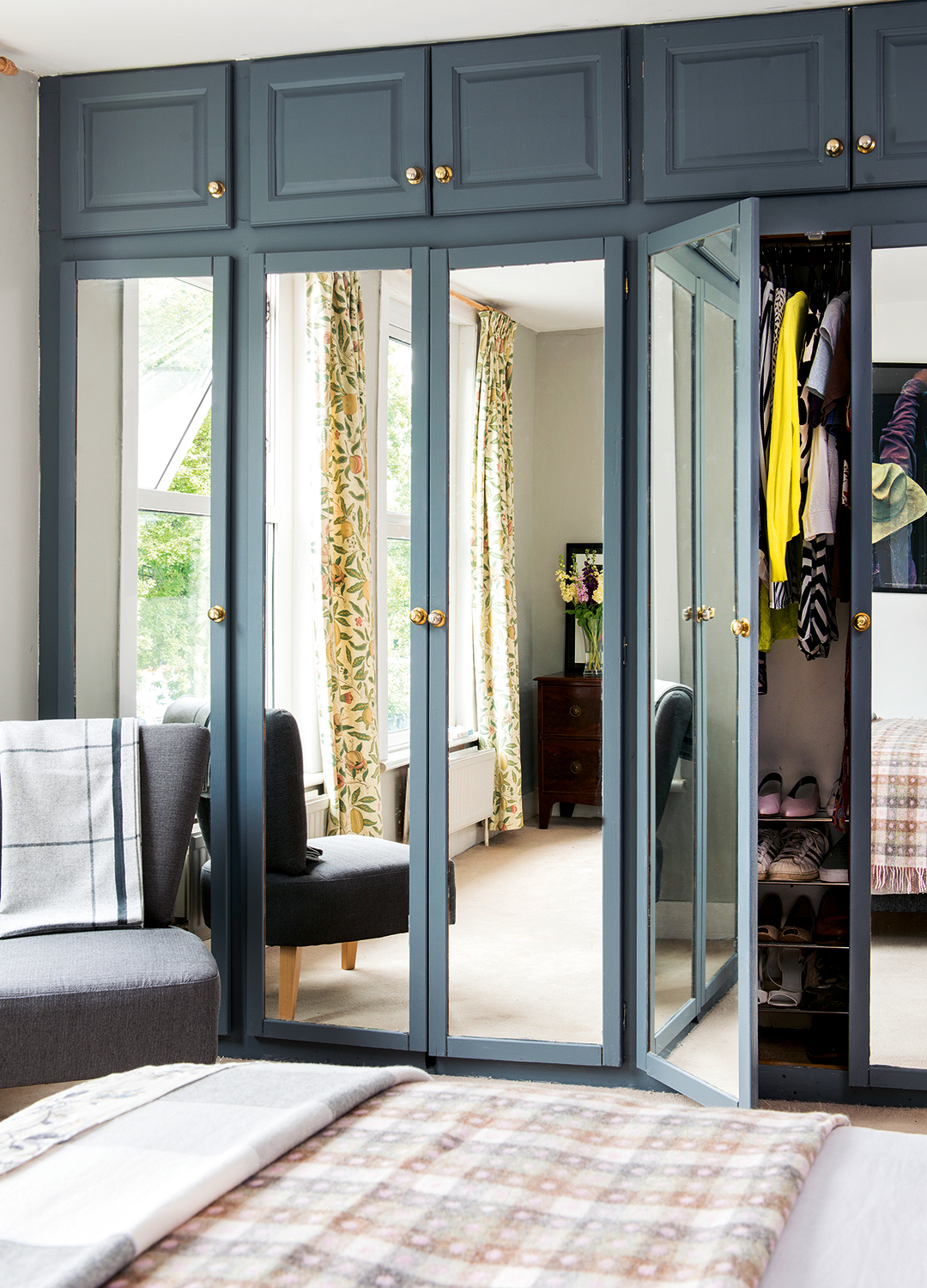 Bedroom with blue built-in floor to ceiling wardrobes