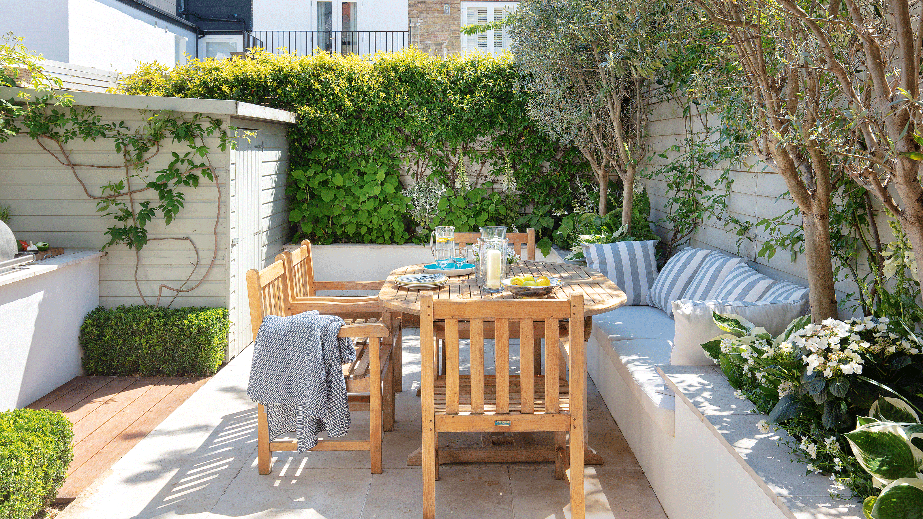 Outdoor striped awning over dining table and chairs