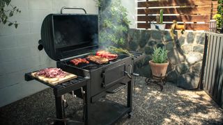 A grill cooking in a backyard