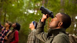 Best states in the USA for bird-watching: People using binoculars to bird watch 