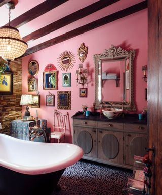 Pink bathroom with a gallery wall of art