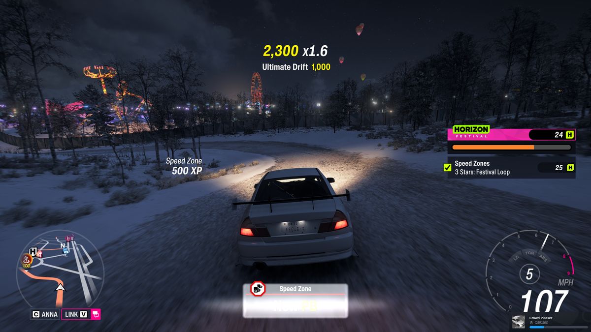 Forza Horizon 6 Festival Loop: A Mitsubishi Lancer Evolution driving down the speed zone at night.