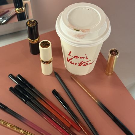 Photo of Louis Vuitton makeup products next to a branded coffee cup
