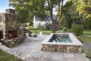 Plunge pool in garden with fireplace