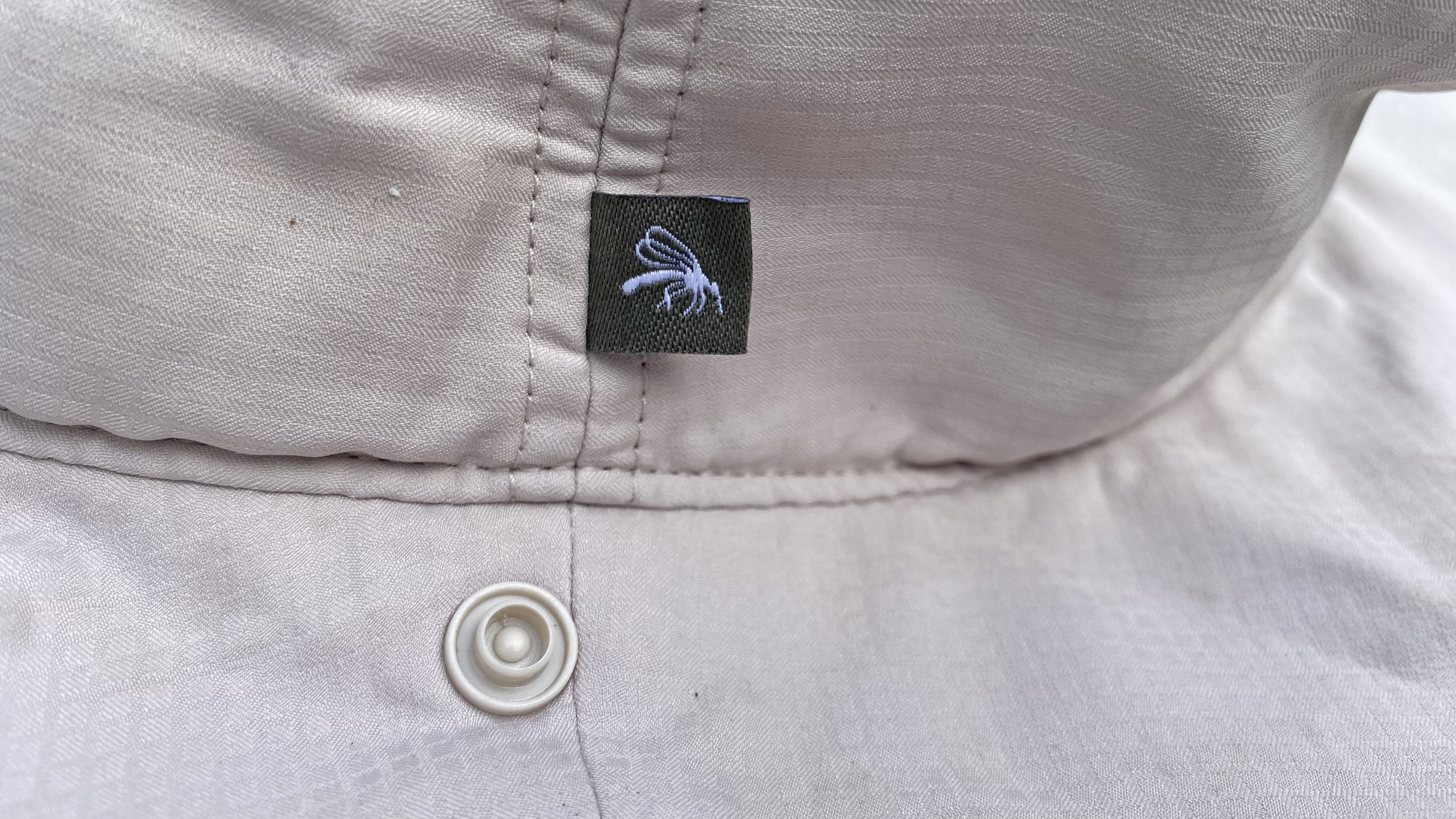 The Skien Valley Booney Hat, showing the popper where the face net attaches, and the Insect shield logo
