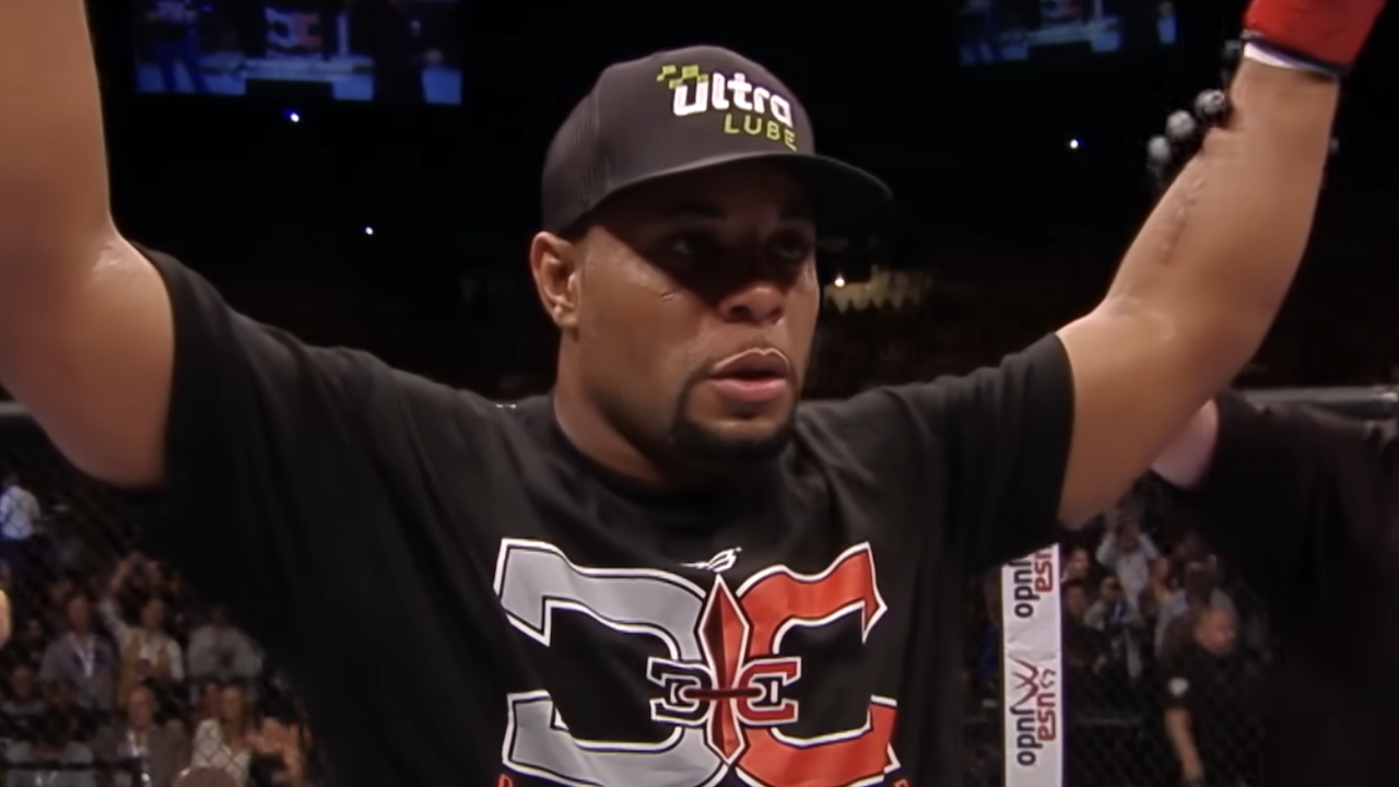 Daniel Cormier raising hands after beating Patrick Cummins in UFC