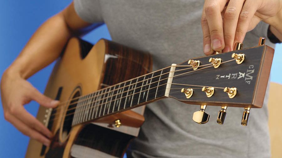 Man testing an acoustic guitar