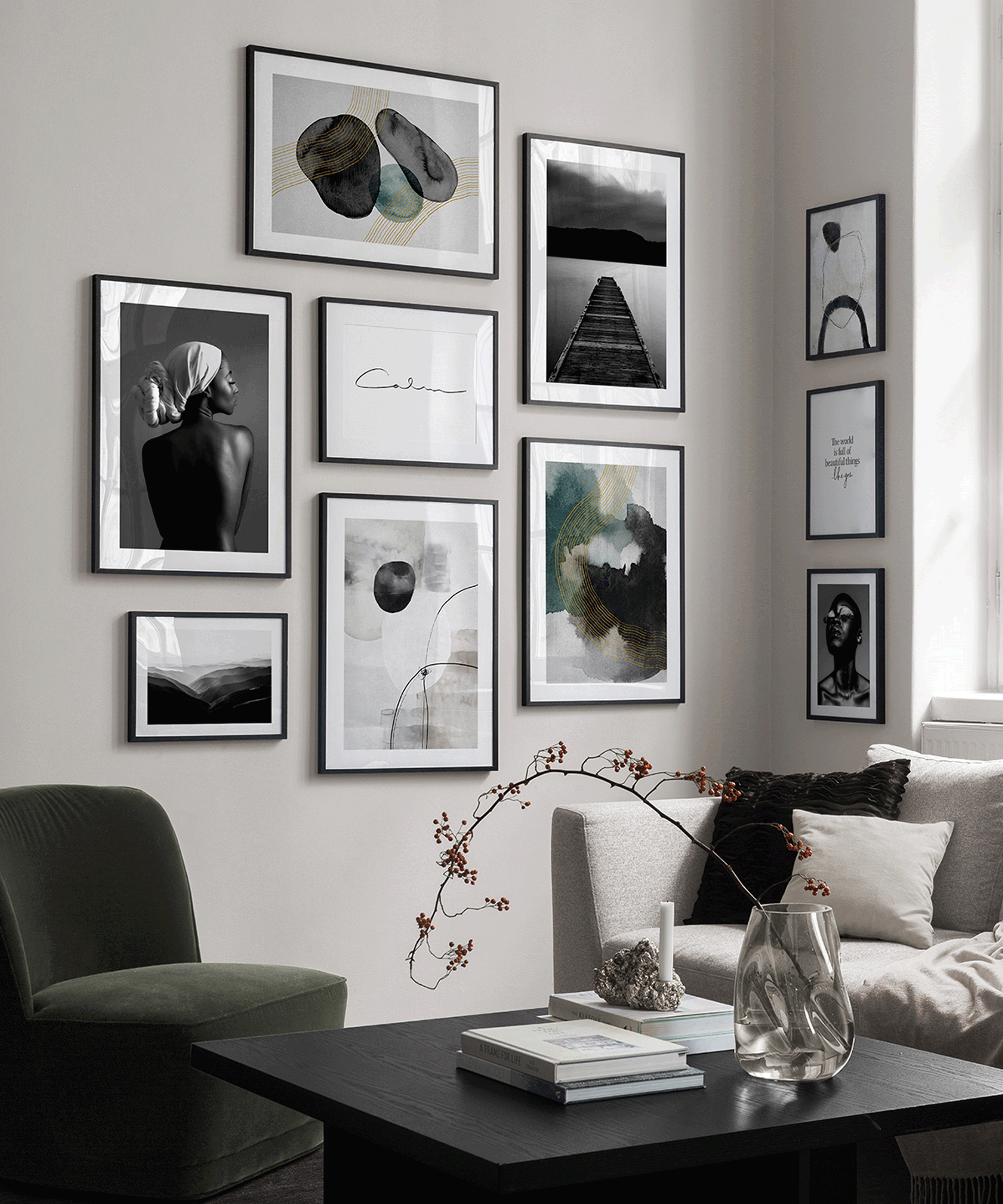 wall of moody monochrome prints in a living area