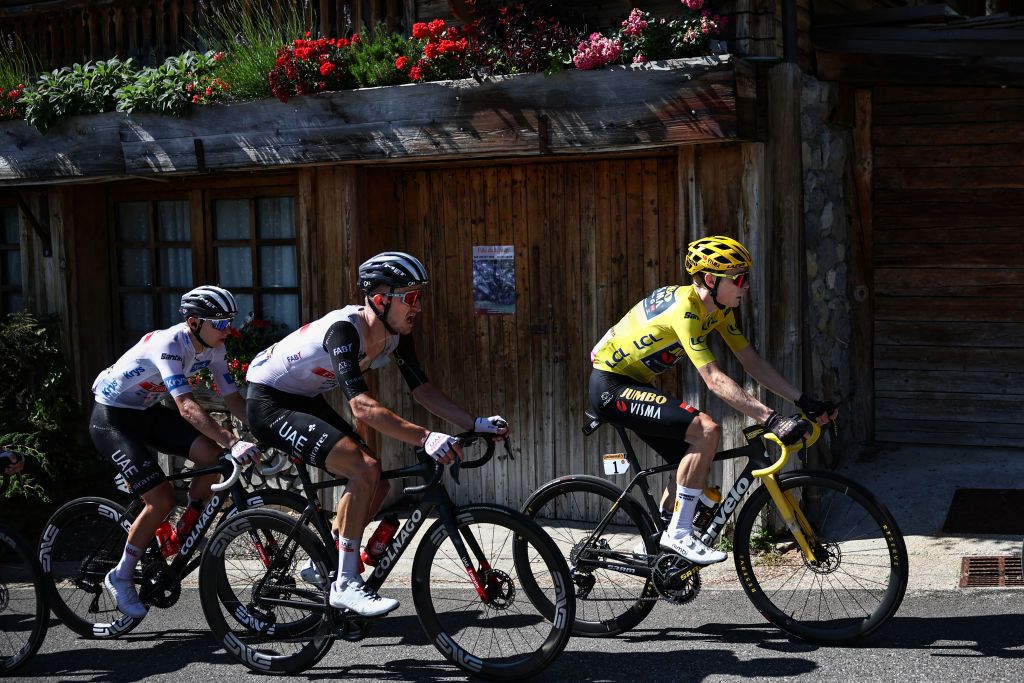 Jumbo-Visma's Danish rider Jonas Vingegaard wearing the overall leader's yellow jersey (R) cycles ahead of Jumbo-Visma's Belgian rider Tiesj Benoot (C) and UAE Team Emirates' Slovenian rider Tadej Pogacar wearing the best young rider's white jersey (L) in the French Alps during the 15th stage of the 110th edition of the Tour de France cycling race, 179 km between Les Gets Les Portes du Soleil and Saint-Gervais Mont-Blanc, in eastern France, on July 16, 2023. (Photo by Anne-Christine POUJOULAT / AFP)