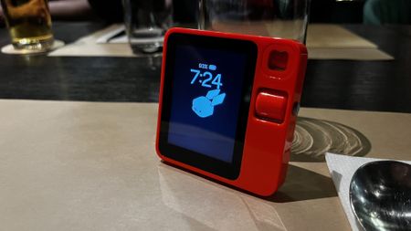 The Rabbit R1 on a table at a restaurant