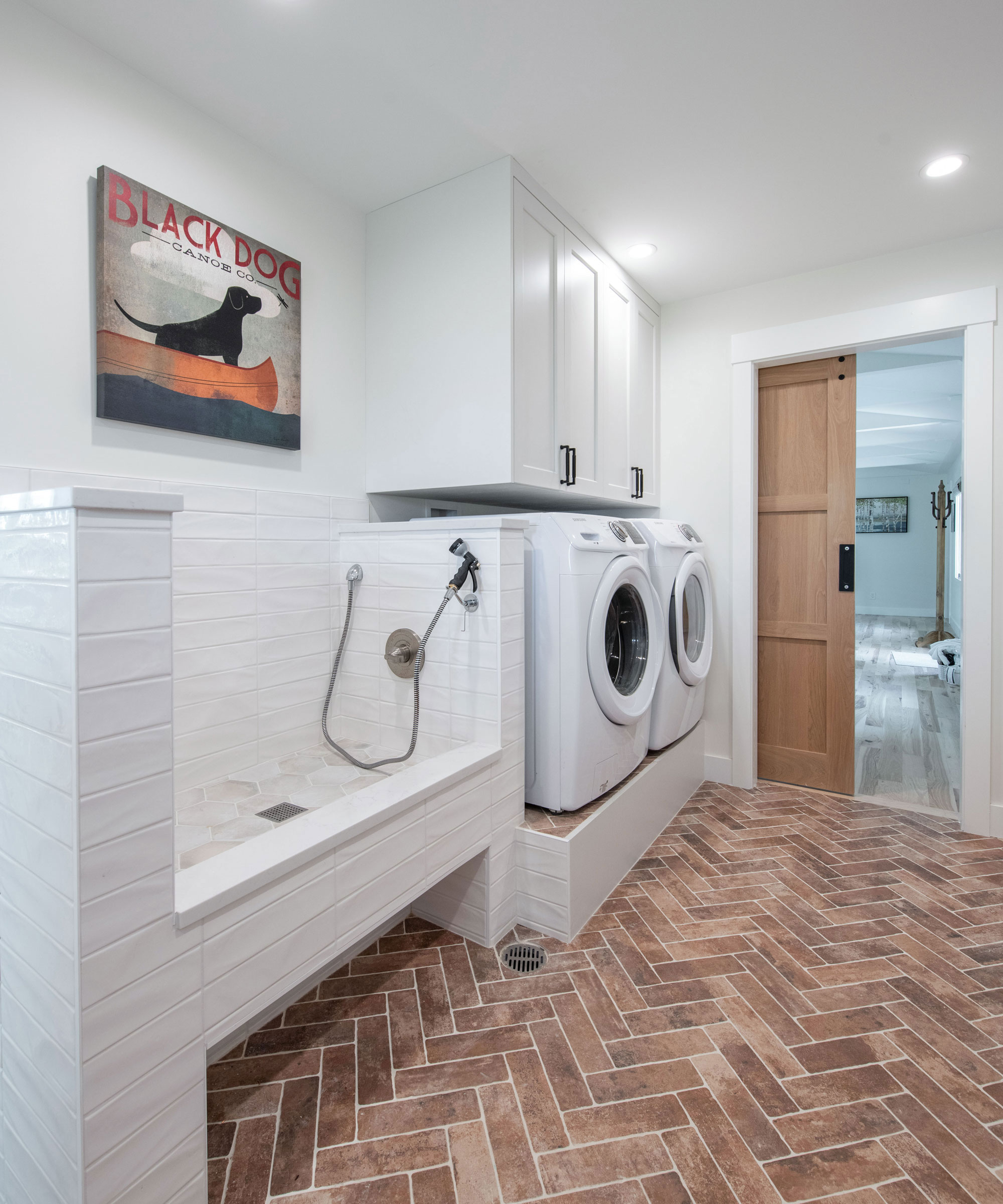 utility room with dog shower and herringbone flooring