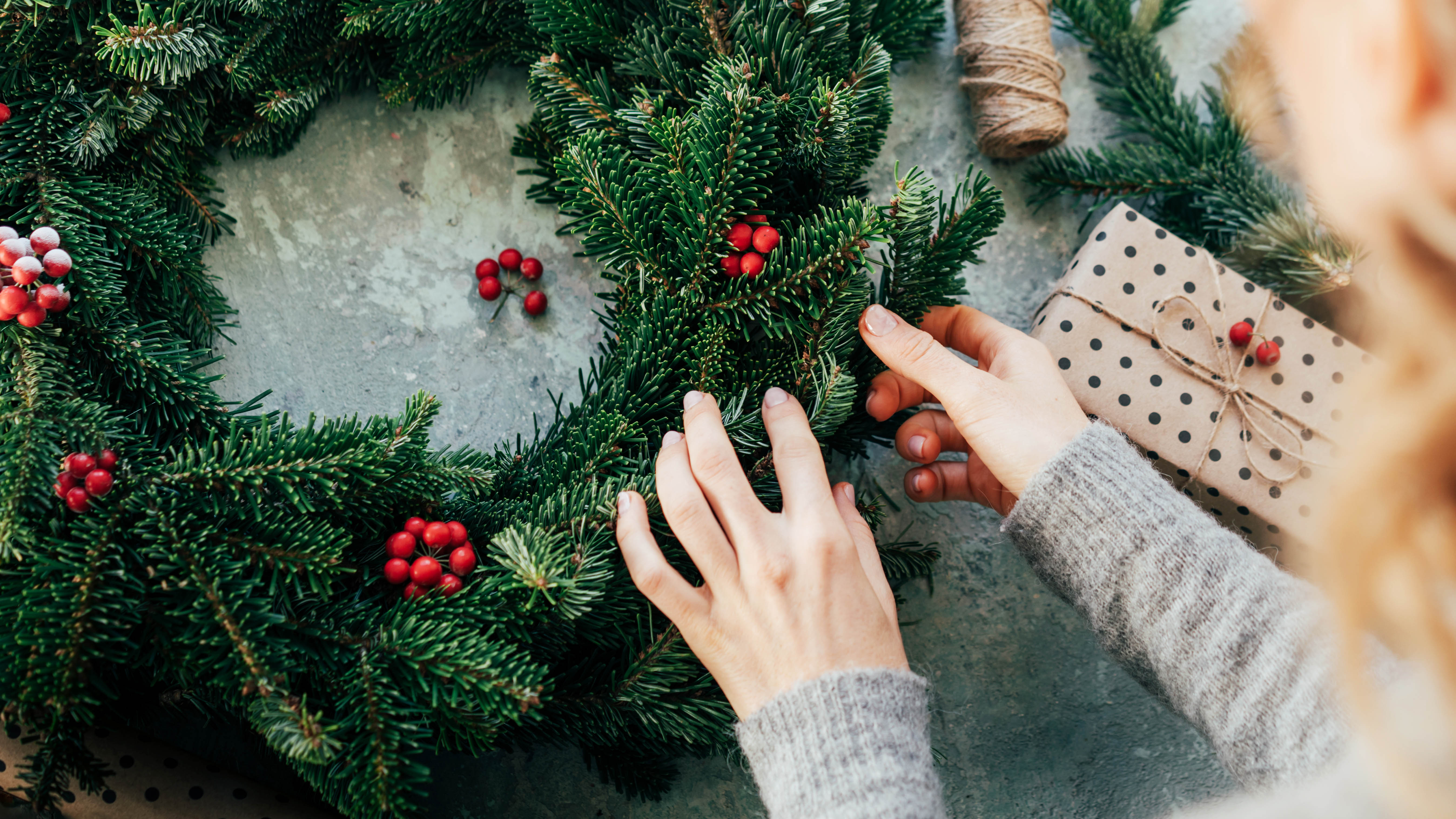 A woman makes a Christmas wreath