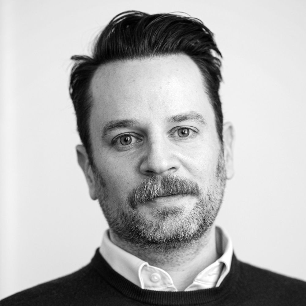 A black and white headshot of Jordan Conrad