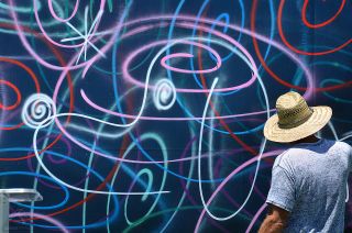 Artist Kenny Scharf completes his space-themed Peanuts mural at Space Center Houston on Thursday, April 25, 2019.