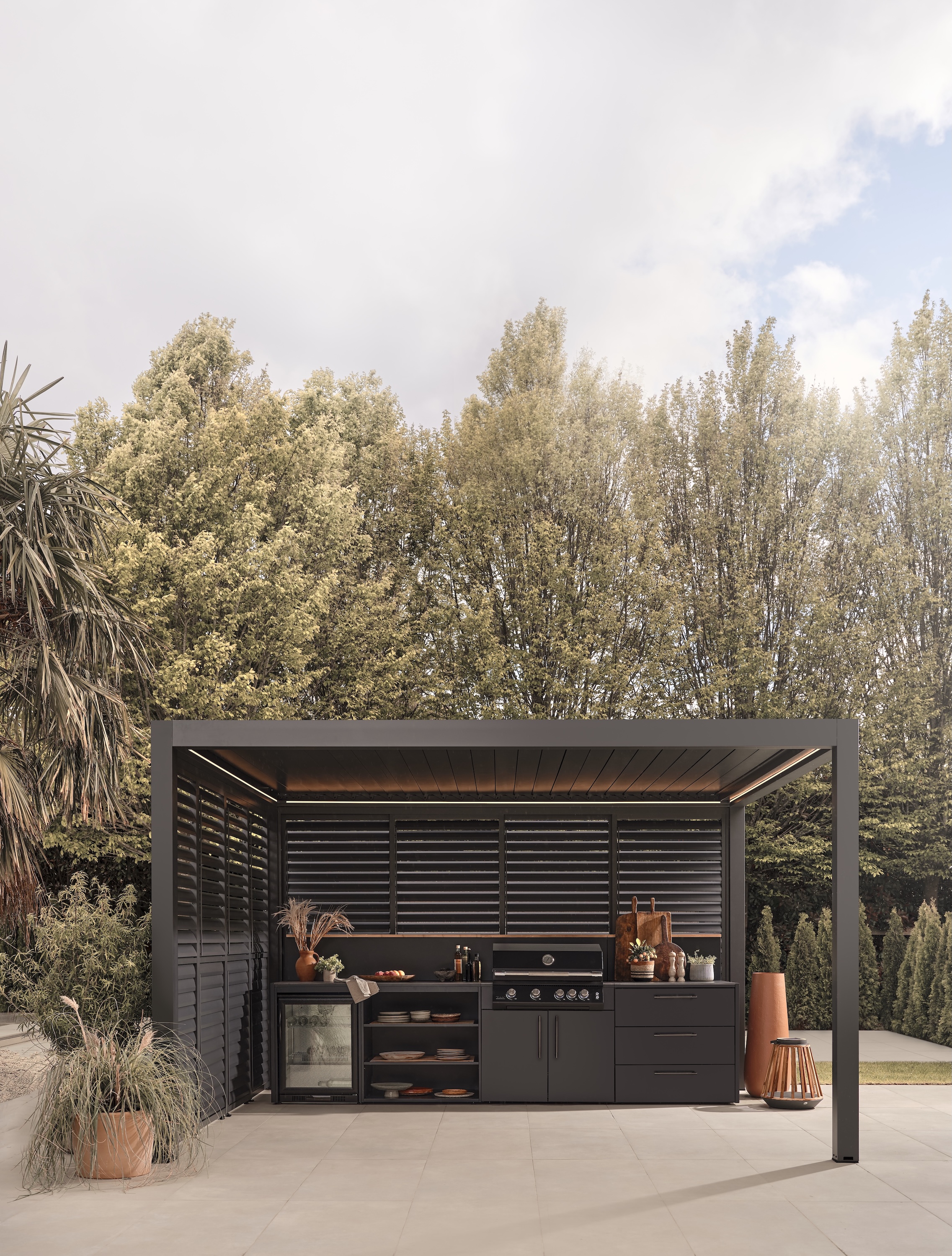pergola covered outdoor kitchen all in sleek, matte black