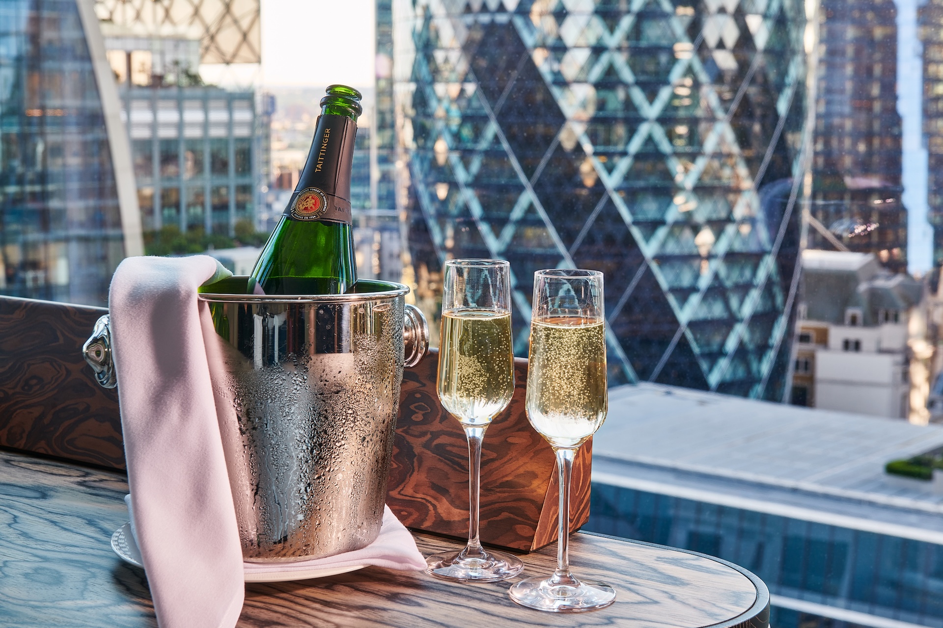 a Bottle and two glasses on a table at the Pan Pacific
