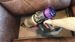 Cleaning a couch with a vacuum cleaner