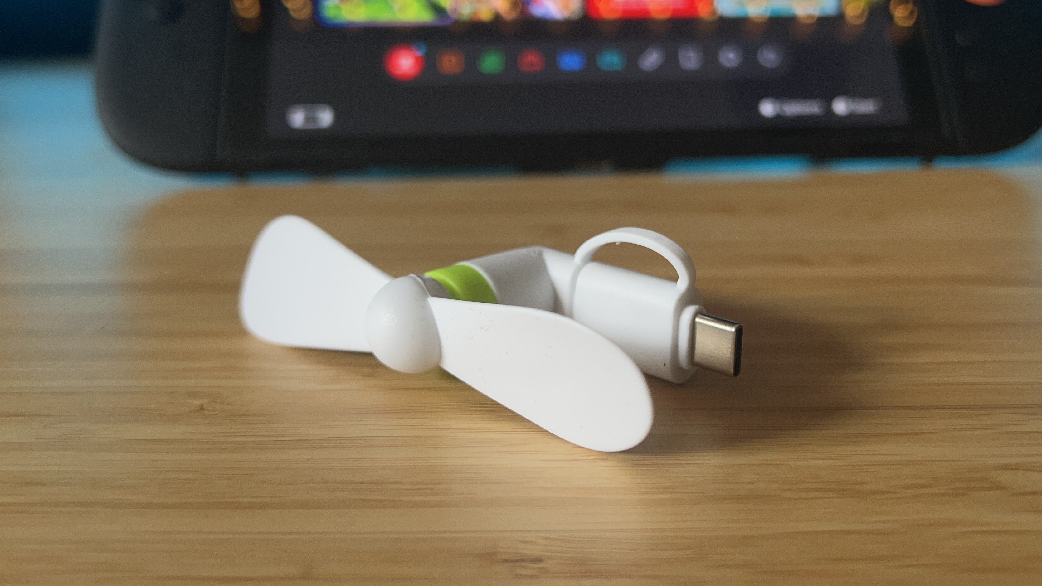 Jowxsx 2 in 1 Type C fan on a wooden desk with a Nintendo Switch 2 in the background