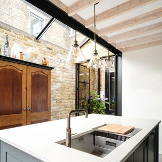 kitchen with brick and white wall and white counter