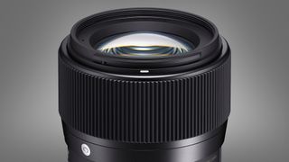The Sigma 56mm f/1.4 DC DN lens on a grey background