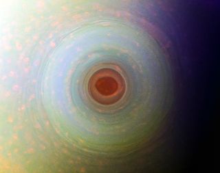 Saturn's south pole looks a bit unsettling in this infrared view from NASA's Cassini spacecraft. At the center of a 5,000-mile-wide (8,000 kilometers) storm is an eerie red "eye" that looks similar to the eye of a hurricane on Earth. However, this strange vortex doesn't behave in the same way as our Earthly hurricanes, with its cloudy rings rising 20 to 45 miles (30-75 km) above the storm's center. Cassini captured this view from Saturn's orbit in 2006, and citizen scientist Kevin Gill reprocessed it using near-infrared filtered images.