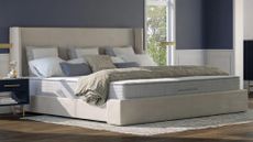 The Nolah Luxe Alaskan King Mattress in a large bedroom, with four pillows showing just how bug the mattress is
