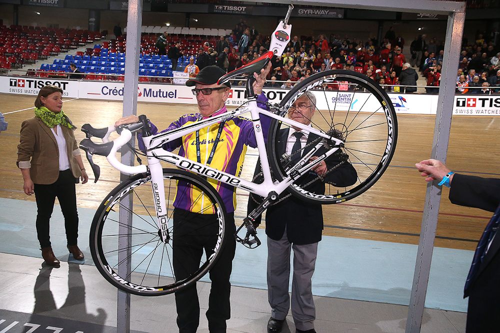 Officials check Marchand's bike before his attempt.