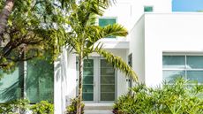 Luxury modern entrance architecture of house in Florida city island on travel, sunny day, property real estate with garden landscaping decoration 