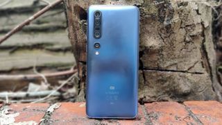 Xiaomi Mi 10 Pro nojaamassa puuta vasten