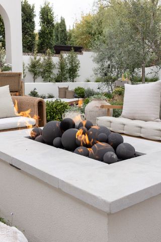 fire pit with spherical fire pit media by Garden Studio Design