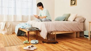 The Roomba Mini cleaning under a bed