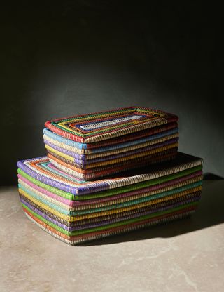 2 colorful woven baskets of two sizes stacked on top of each other