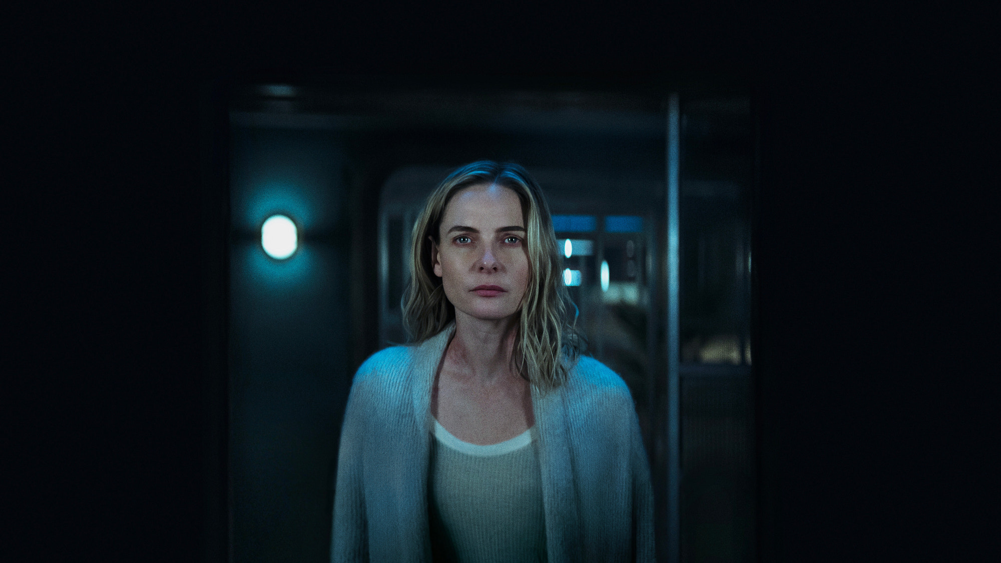 a woman looking into a mirror
