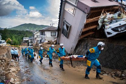 Police in Japan's Hiroshima prefecture respond to mudslides