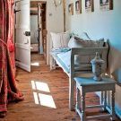 landing passage with antique bench long curtain and white door
