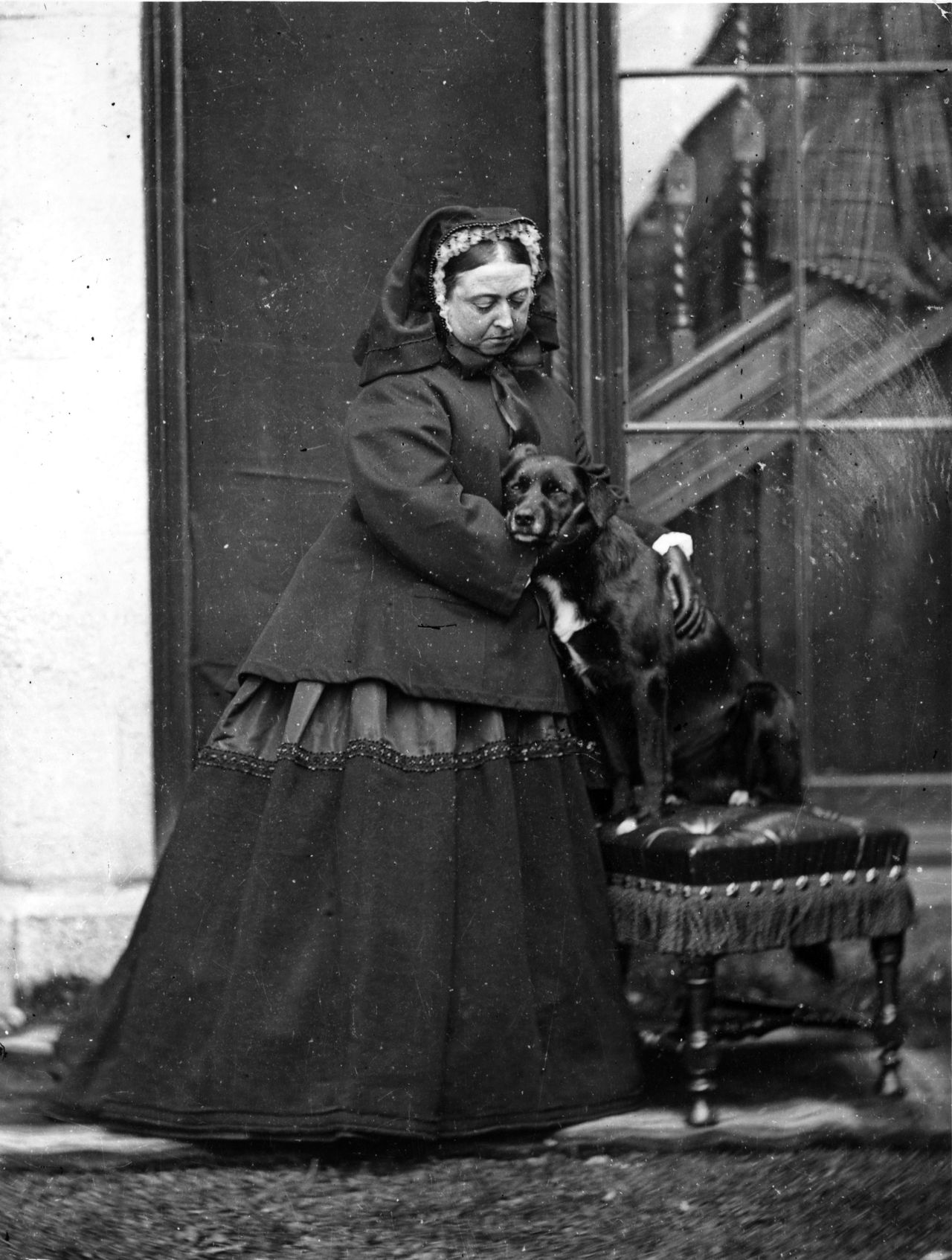 Three historical images showing Queen Victoria with her border collies: a studio portrait of the Queen seated in mourning dress with a border collie at her feet; a photograph of her standing beside another border collie placed on a small upholstered stool; and a statue of Noble, her beloved border collie, set on a stone plinth in a wooded area at Balmoral.