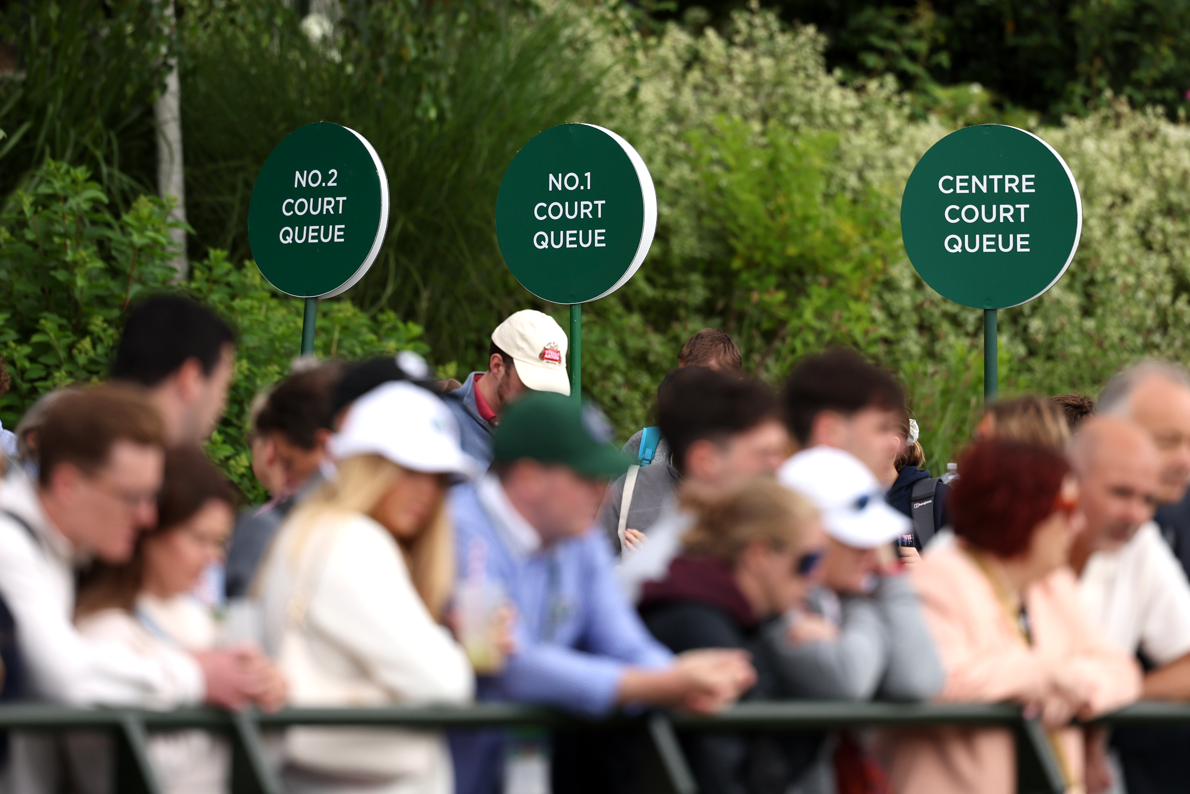 Spectators queue for Number Two Court, Number One Court and Centre Court during day two of The Championships Wimbledon 2024 at All England Lawn Tennis and Croquet Club