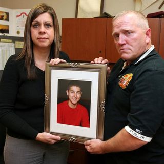 Michelle and David Rauls hold a photograph of their son Nicholas, 13, on Dec. 1 at Knox Hall. Nick committed suicide Feb. 7, 2010, at the family's Elgin, Okla., home.