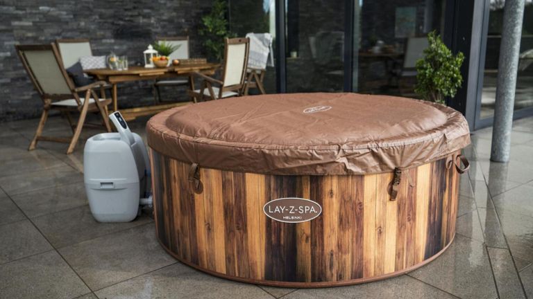 Lay-Z-Spa Helsinki 7 Person AirJet Hot Tub, wooden effect hot tub with cover on in garden on patio
