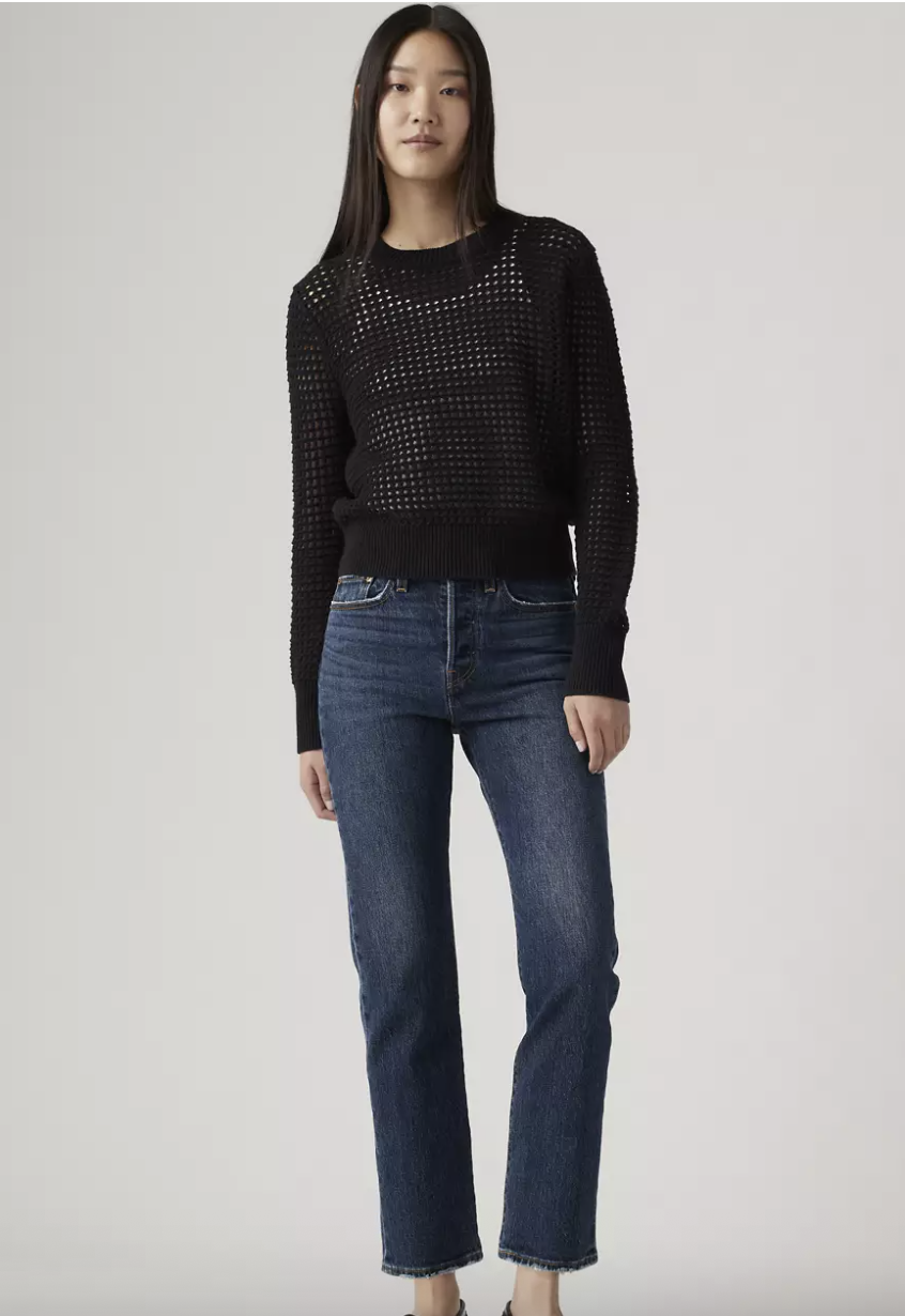 a model wearing levi's blue straight leg jeans